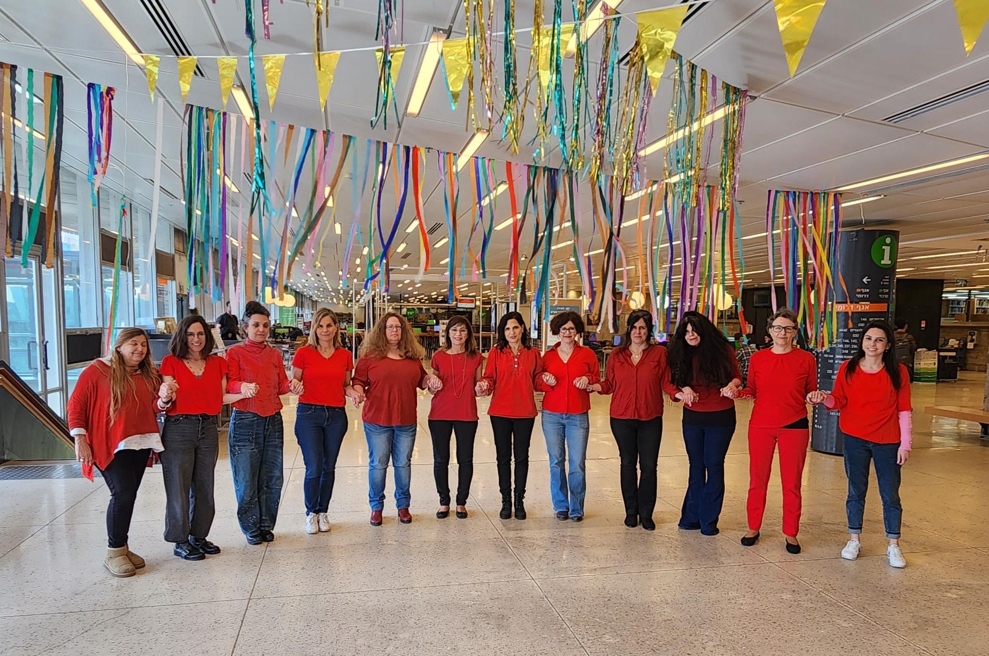 Read more about the article The Library’s Female team composing a red human necklace on International Women’s Day